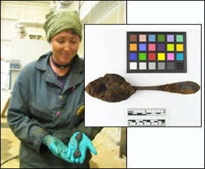 A Mariners’ Museum conservator holds one of the silver spoons found in the turret. Courtesy The Mariners’ Museum.