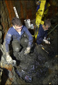 Archaeologists, Wayne Lusardi (left) and John Broadwater began excavating human remains while the turret was still en route to Hampton Roads. Courtesy <em>Monitor</em> Collection, NOAA