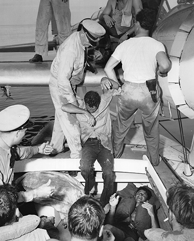 Survivors being pulled out of their raft