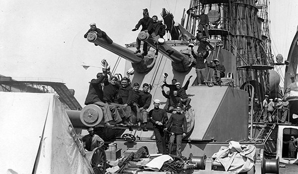 Sailors and Marines posing on the ship’s after turret