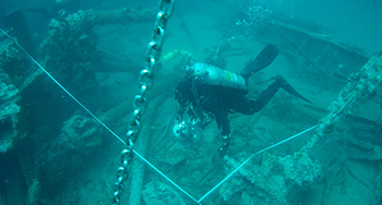 diver examining a shipwreck