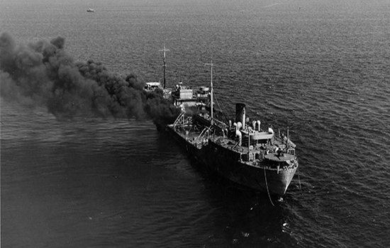 Ship billowing smoke after hitting a mine laid by Degen